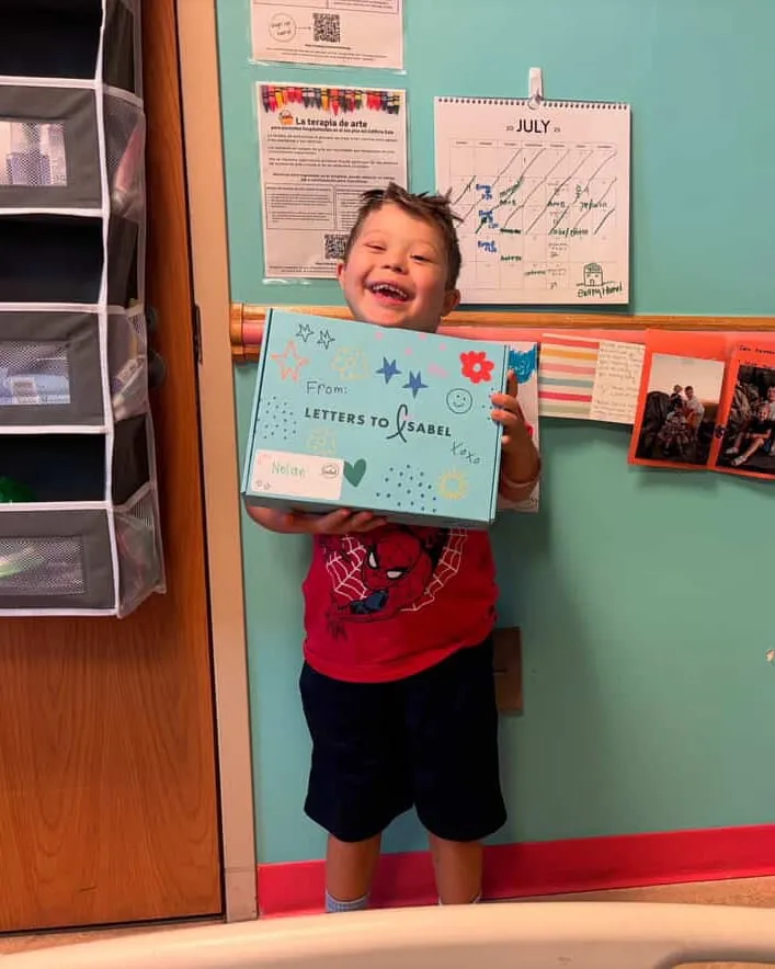 Laughing boy holding up his Boombox in his hospital room