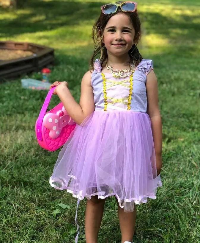Smiling young club member in a tutu holding an Easter basket